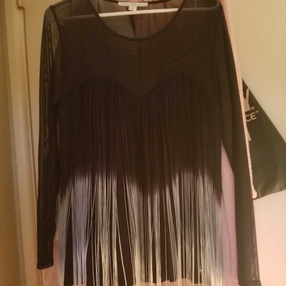 Retro, disco shirt with lots of fringes.